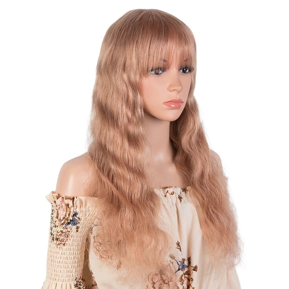 RitzWigs blonde body wave human hair wig with bangs on a mannequin, featuring long wavy Peruvian Remy hair.