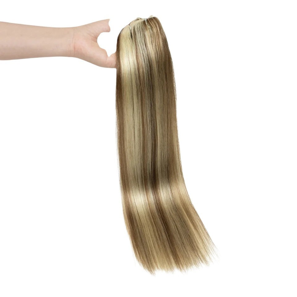 RitzWigs straight blonde human hair clip-in extensions with double weft held in a hand