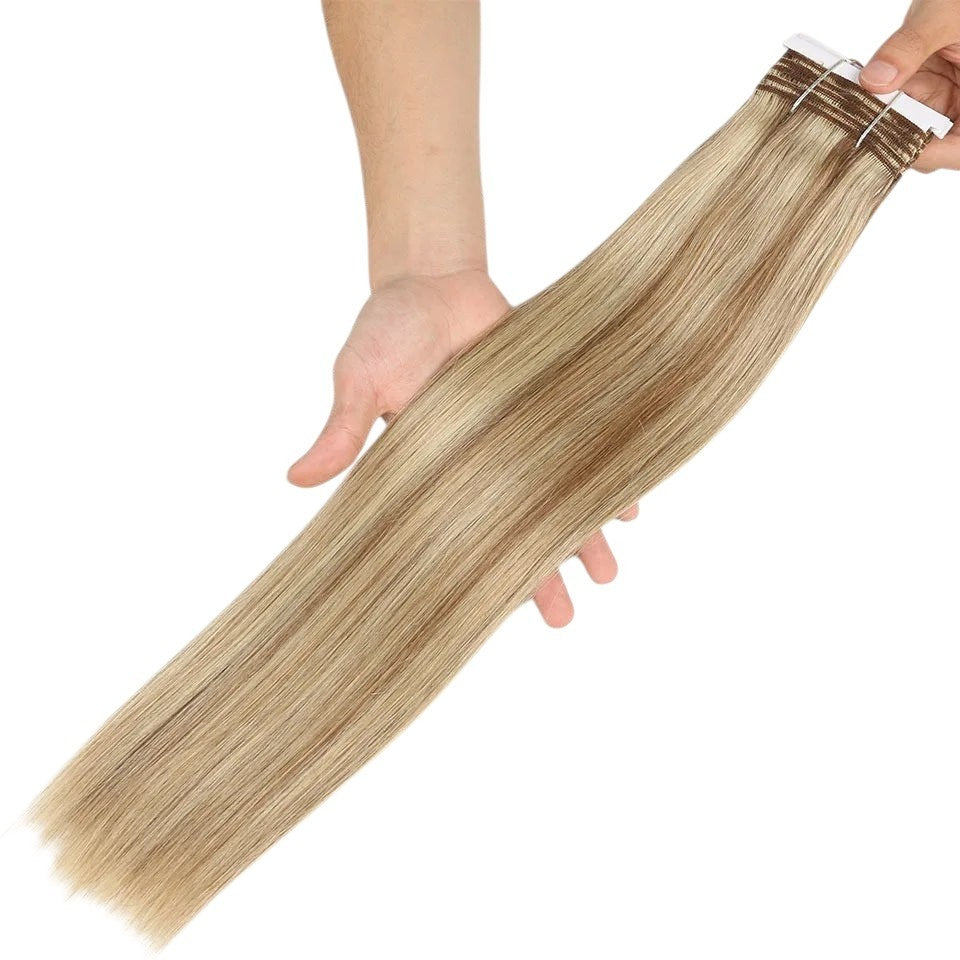 RitzWigs P6/613 blonde straight human hair weave bundle held in hand showing silky texture and highlights