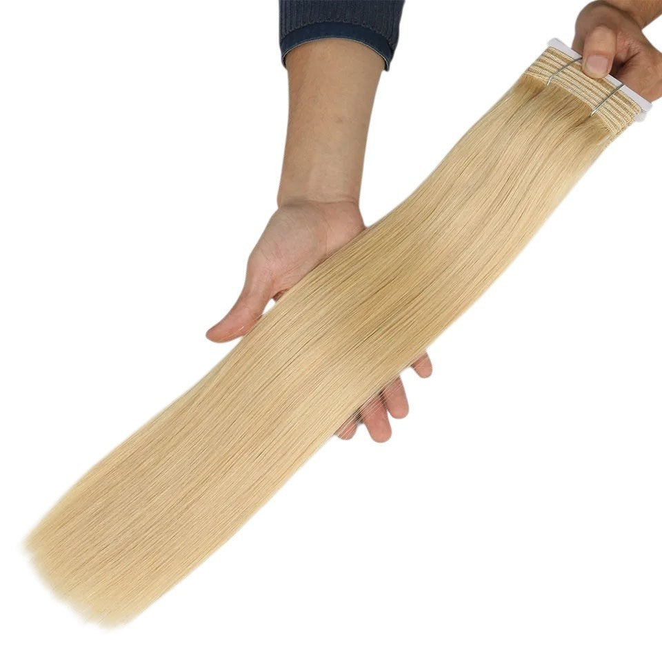 RitzWigs blonde straight human hair weave bundle held in hand showing silky texture and high quality remy extensions