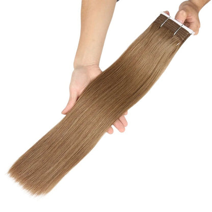 RitzWigs silky straight blonde human hair weave bundle held in hands against a white background