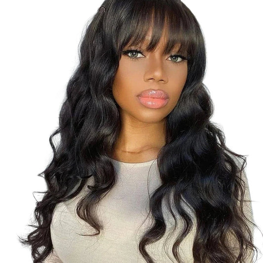 RitzWigs body wave human hair wig with bangs on a model, featuring natural black wavy texture and fringe style.