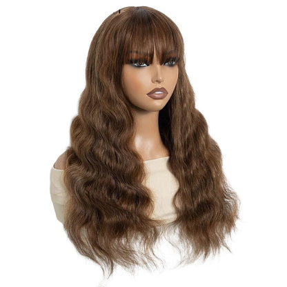 RitzWigs brown body wave human hair wig with bangs on a mannequin head, featuring a natural wavy texture.