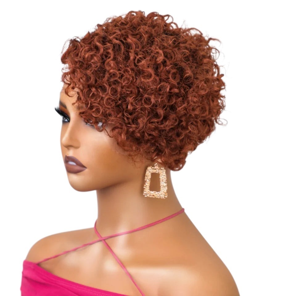 RitzWigs ginger curly pixie cut human hair wig on a mannequin head with gold earrings