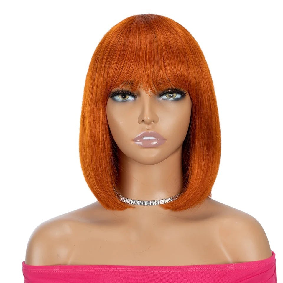 RitzWigs ginger orange straight human hair bob wig with bangs on a mannequin, 180D density Remy Brazilian hair.
