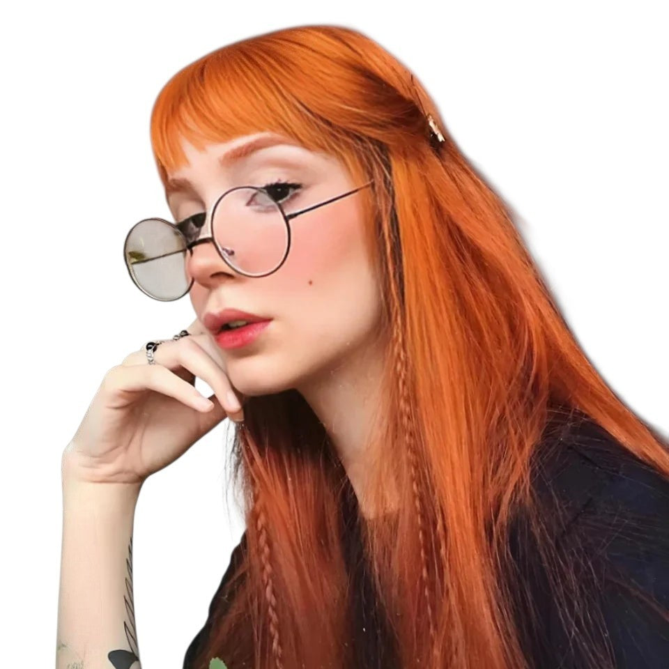 RitzWigs ginger long straight human hair wig with bangs worn by a woman with glasses