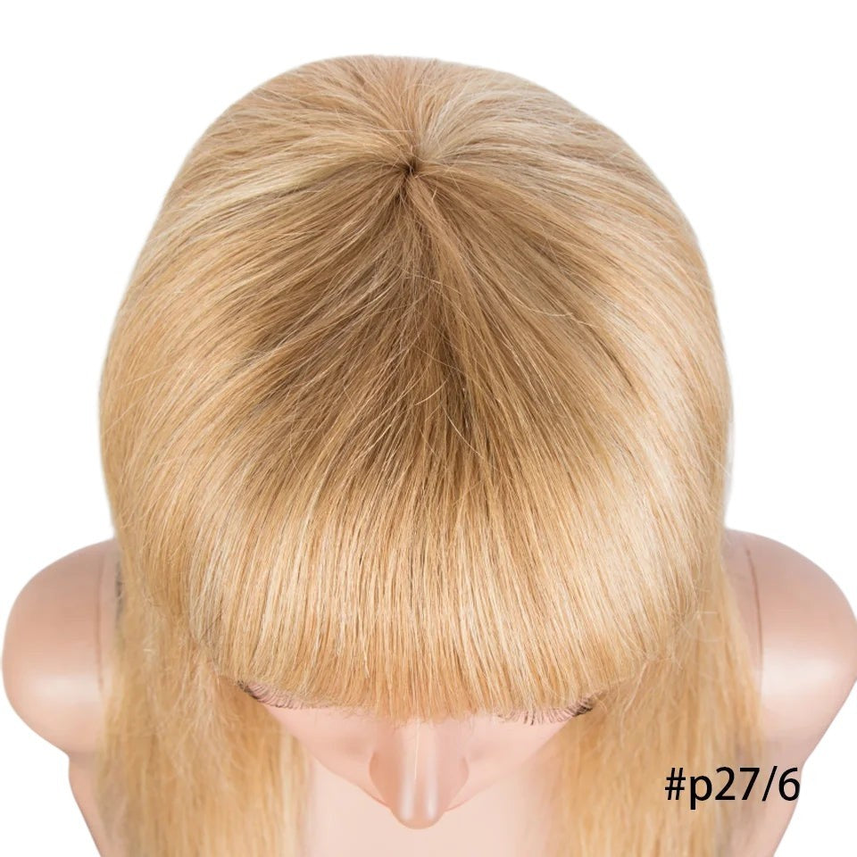 RitzWigs honey blonde highlight human hair wig with bangs on a mannequin head, top view.