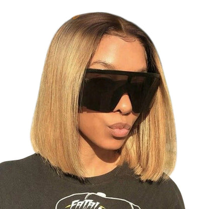 RitzWigs honey blonde straight bob lace front wig with dark roots worn by a woman wearing oversized sunglasses