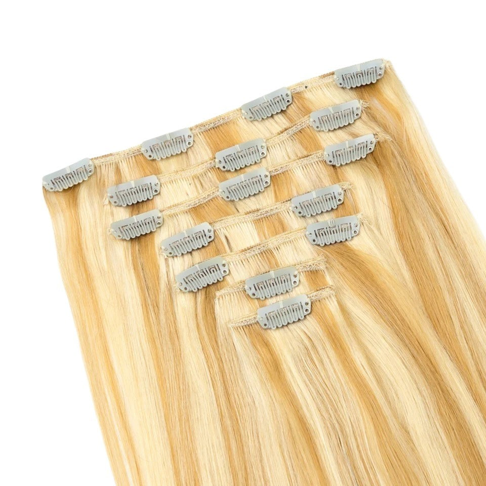 RitzWigs honey blonde straight human hair clip-in extensions with silver metal clips on a white background