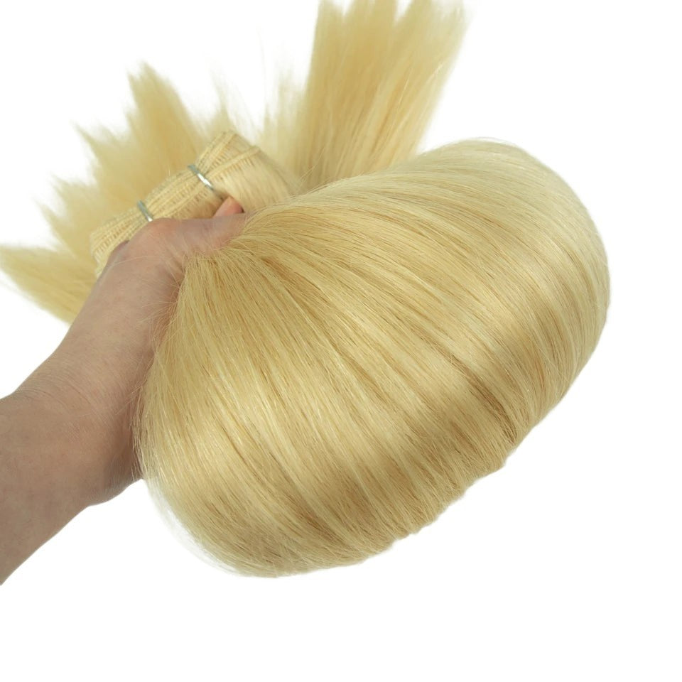 RitzWigs honey blonde 613 straight Remy human hair weave bundle held in hand