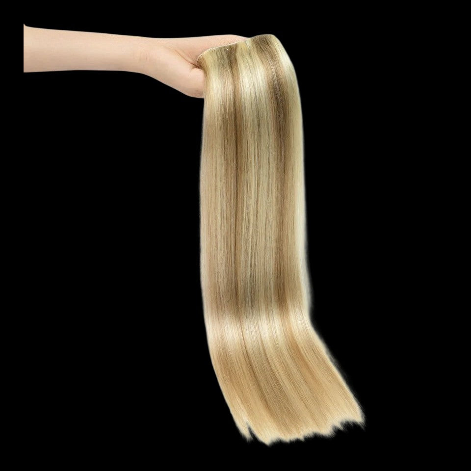 RitzWigs honey blonde straight human hair clip-in extensions held in a hand