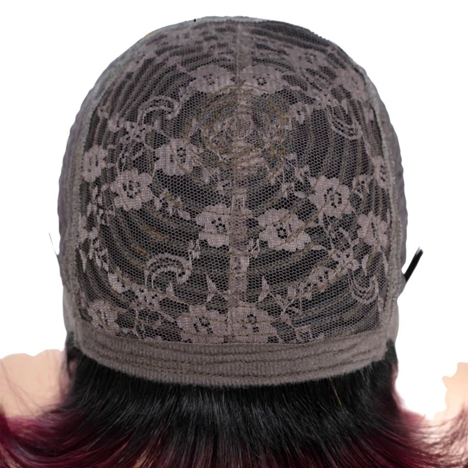 RitzWigs interior view of a machine-made wig cap featuring breathable floral lace construction and adjustable straps.