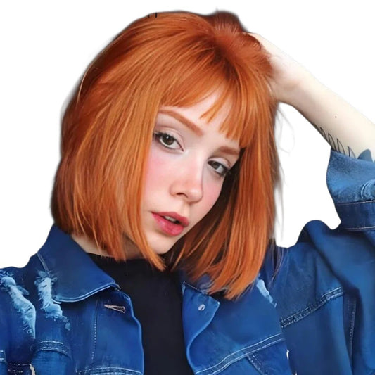 RitzWigs orange ginger straight short bob human hair wig with bangs worn by a woman in a blue denim jacket