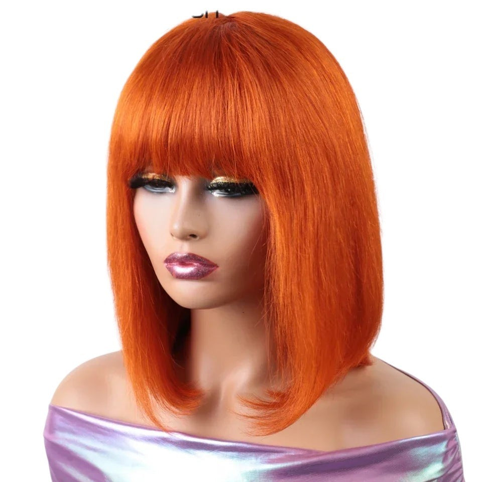 RitzWigs orange straight bob wig with bangs made from Brazilian human hair on a mannequin head