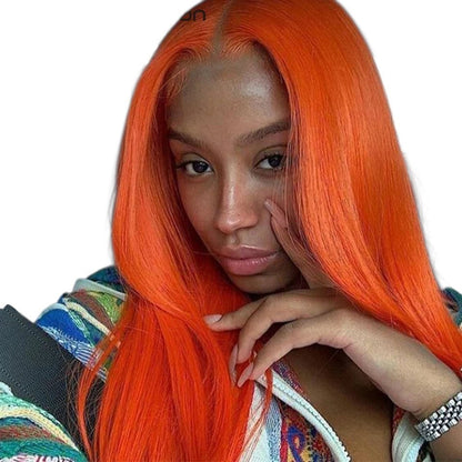 RitzWigs bright orange straight human hair extensions worn by a woman sitting in a car