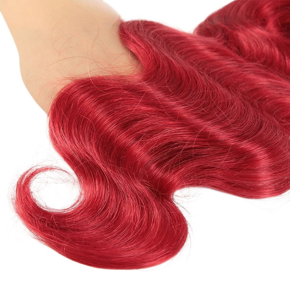 RitzWigs oxblood red Brazilian human hair bundles with a soft body wave texture and silky finish.