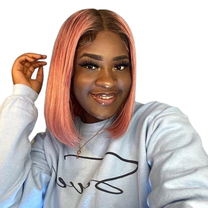 RitzWigs short straight ombre pink bob wig with transparent lace front worn by a smiling woman