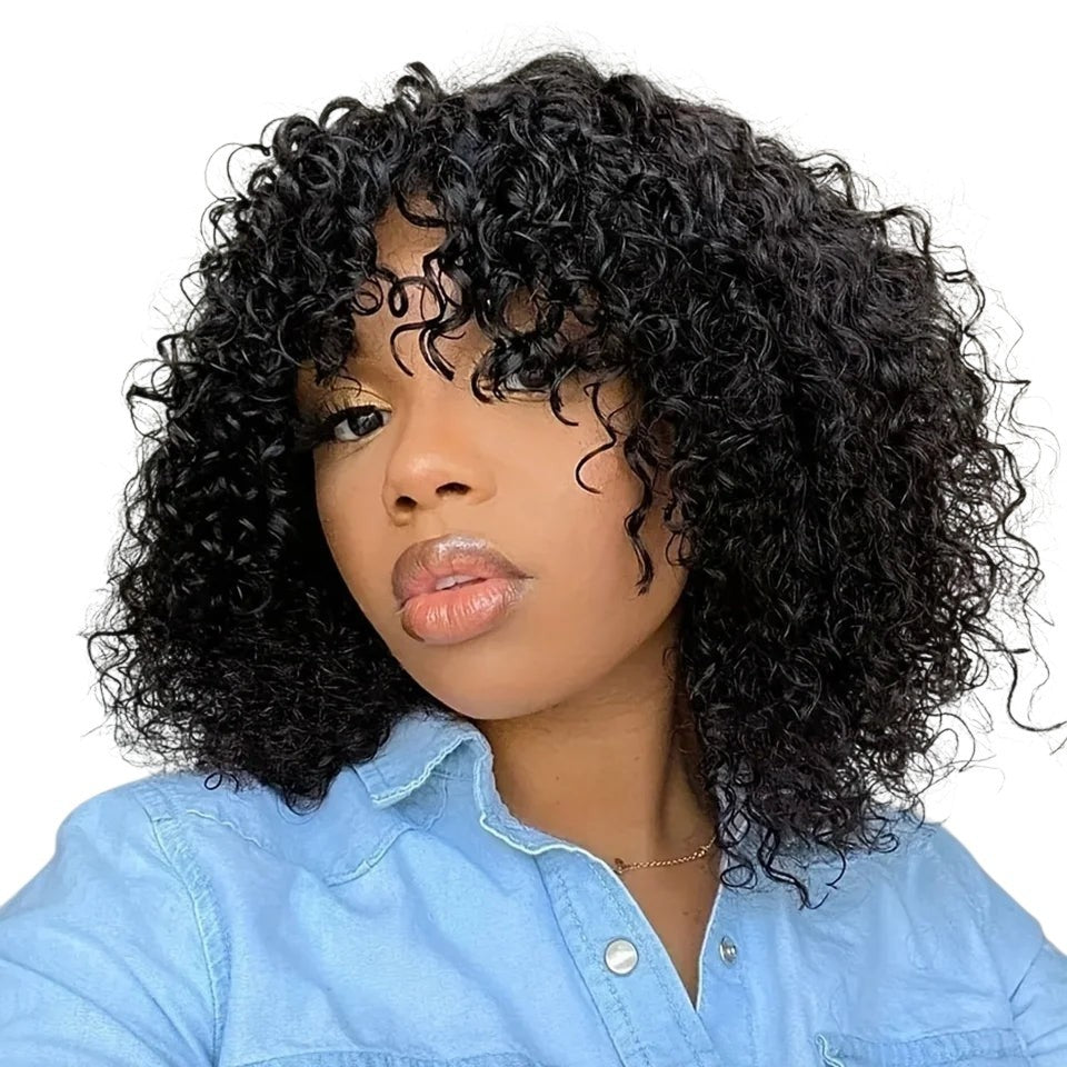RitzWigs short black jerry curly human hair bob wig with bangs worn by a woman in a light blue denim shirt