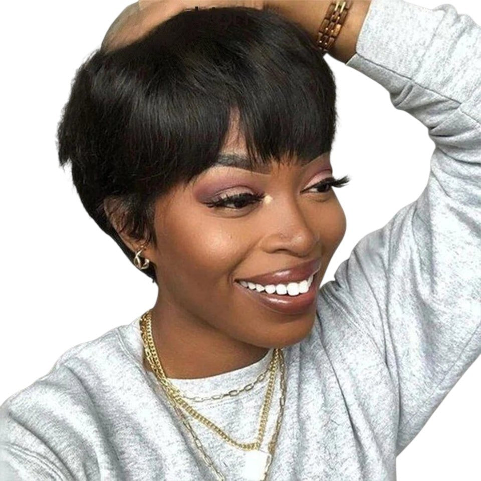 RitzWigs short black pixie cut human hair bob wig with bangs worn by a smiling woman in a grey sweatshirt