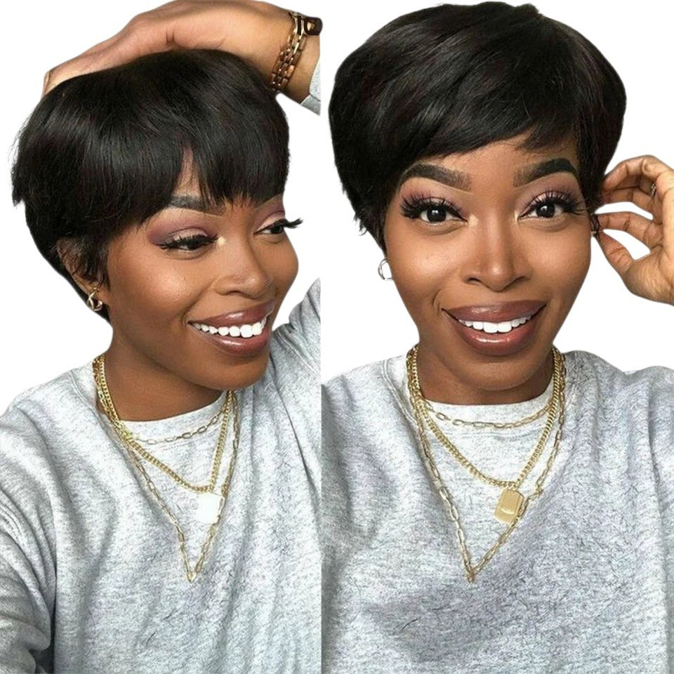 RitzWigs short black pixie cut human hair bob wig with bangs worn by a smiling woman in a grey sweatshirt