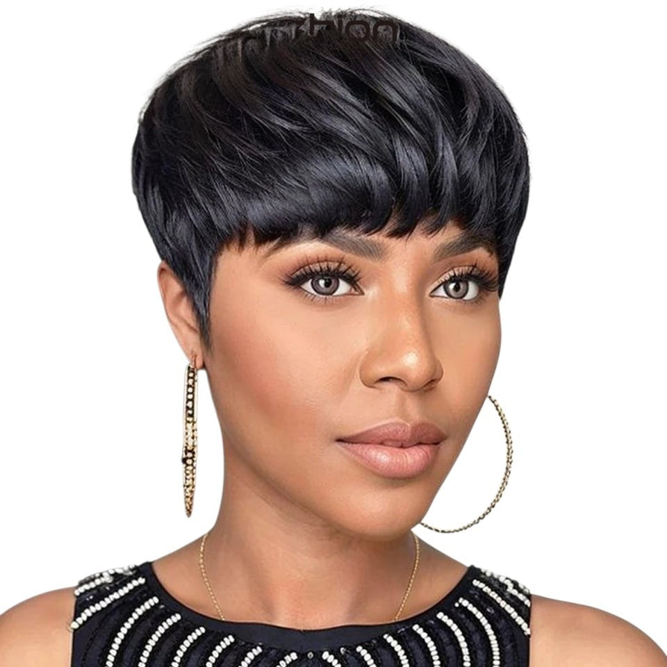 RitzWigs short black straight pixie cut human hair wig with bangs worn by a woman with gold hoop earrings