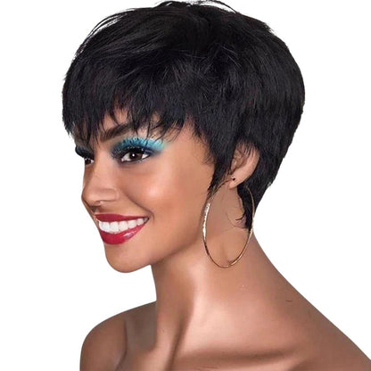 RitzWigs short black pixie cut human hair bob wig with bangs worn by a smiling woman with gold hoop earrings
