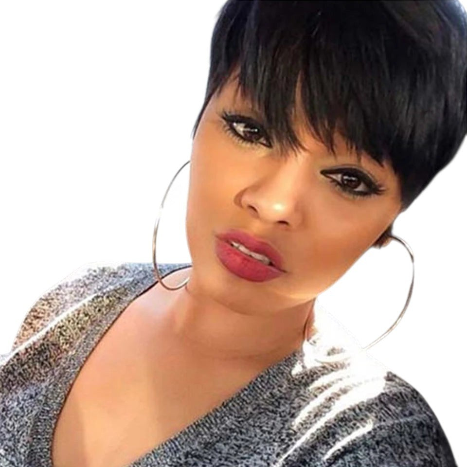 RitzWigs short black pixie cut straight human hair wig with bangs worn by a woman in a car
