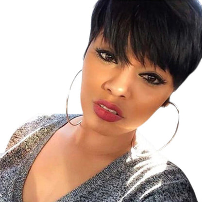 RitzWigs short black pixie cut straight human hair wig with bangs worn by a woman in a car