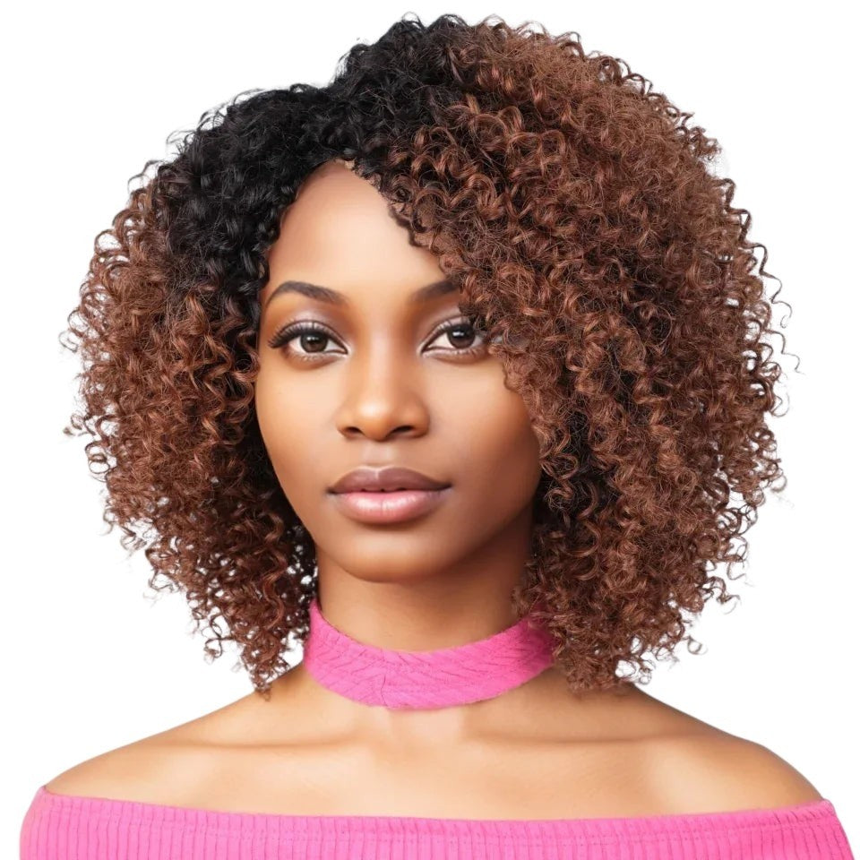 RitzWigs short kinky curly bob wig with brown and black highlights on a model wearing a pink off-shoulder top