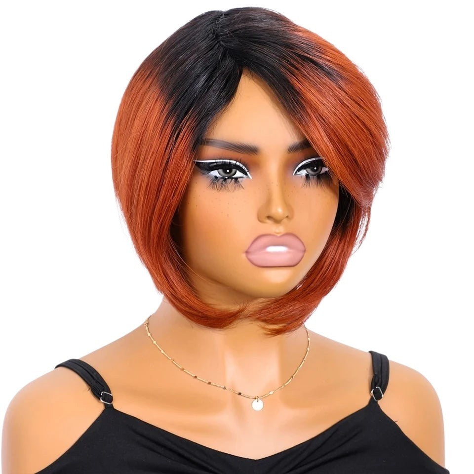 RitzWigs short straight bob human hair wig with dark roots and vibrant orange tones on a mannequin head