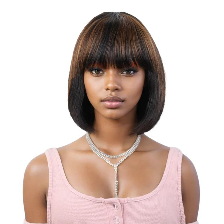 RitzWigs short straight human hair bob wig with bangs in natural brown and honey highlights on a model