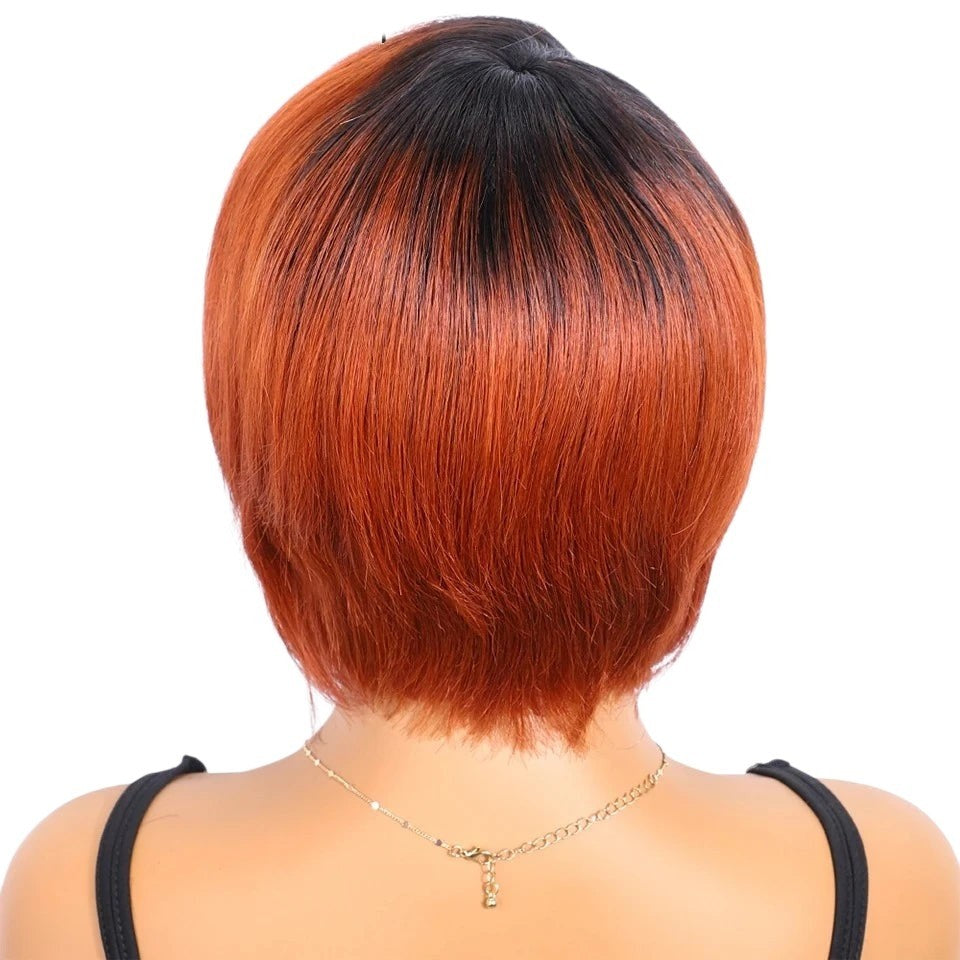 RitzWigs short straight bob human hair wig with dark roots and vibrant orange tones on a mannequin back view