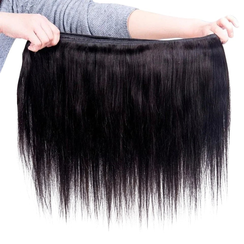 RitzWigs straight black human hair weave bundle held by hands, showing soft texture and machine double weft construction.