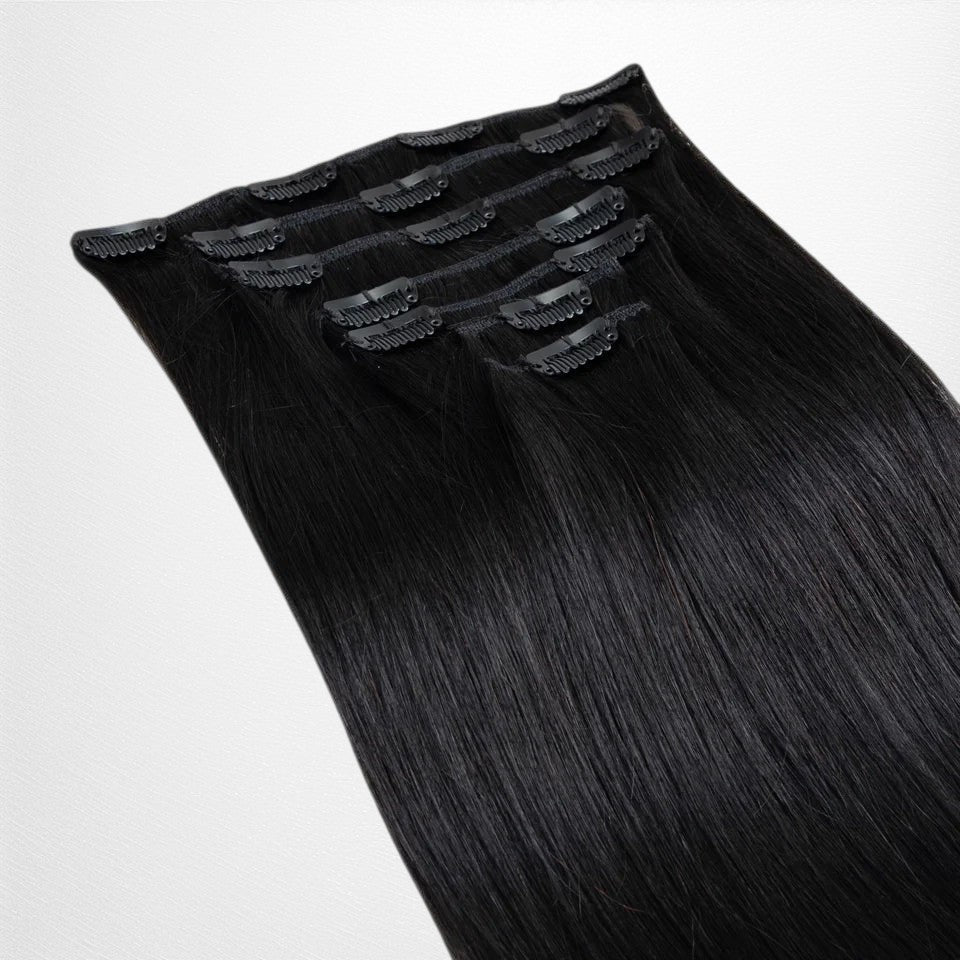 RitzWigs straight natural black human hair clip-in extensions with secure clips on a black background