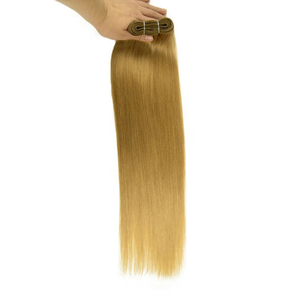 RitzWigs straight blonde human hair weft extension held in hand, showing silky texture and reinforced weft construction.