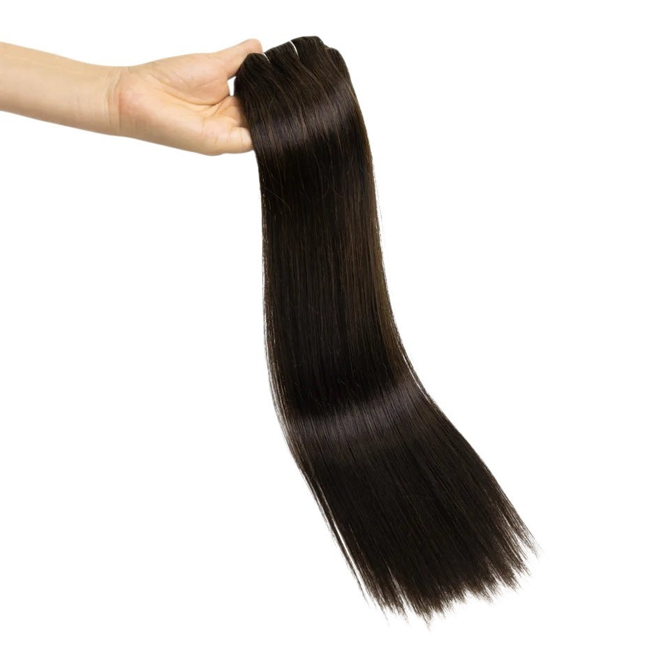 RitzWigs straight brown human hair clip-in extensions held in a hand against a white background.