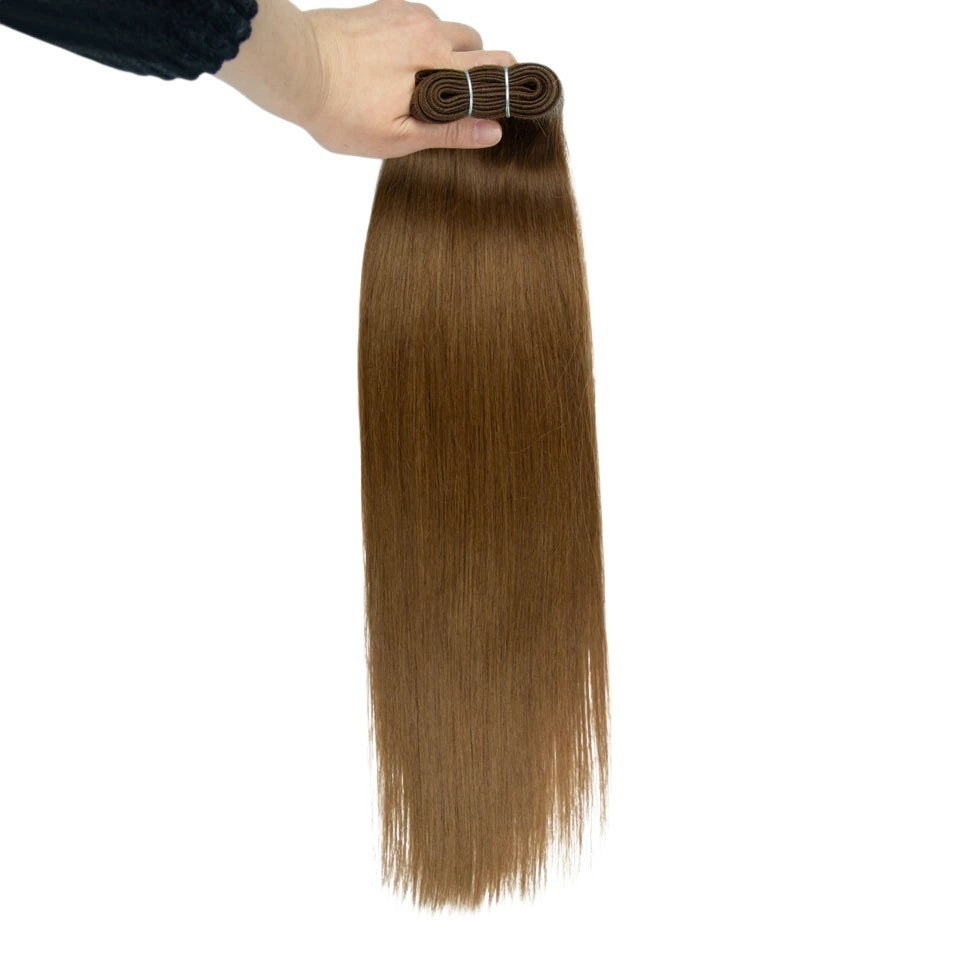 RitzWigs straight brown human hair weave bundle held by hand showing machine double weft construction