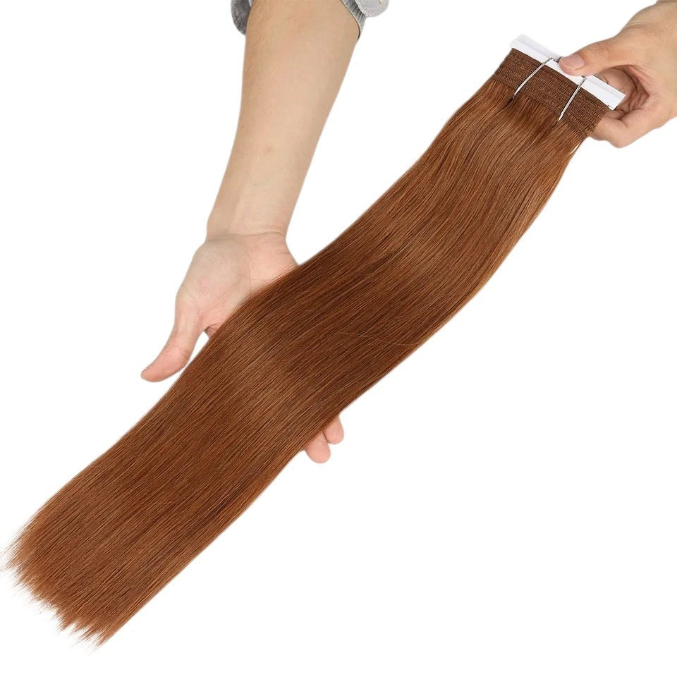 RitzWigs straight human hair tape-in extension in a warm auburn brown shade held in hands