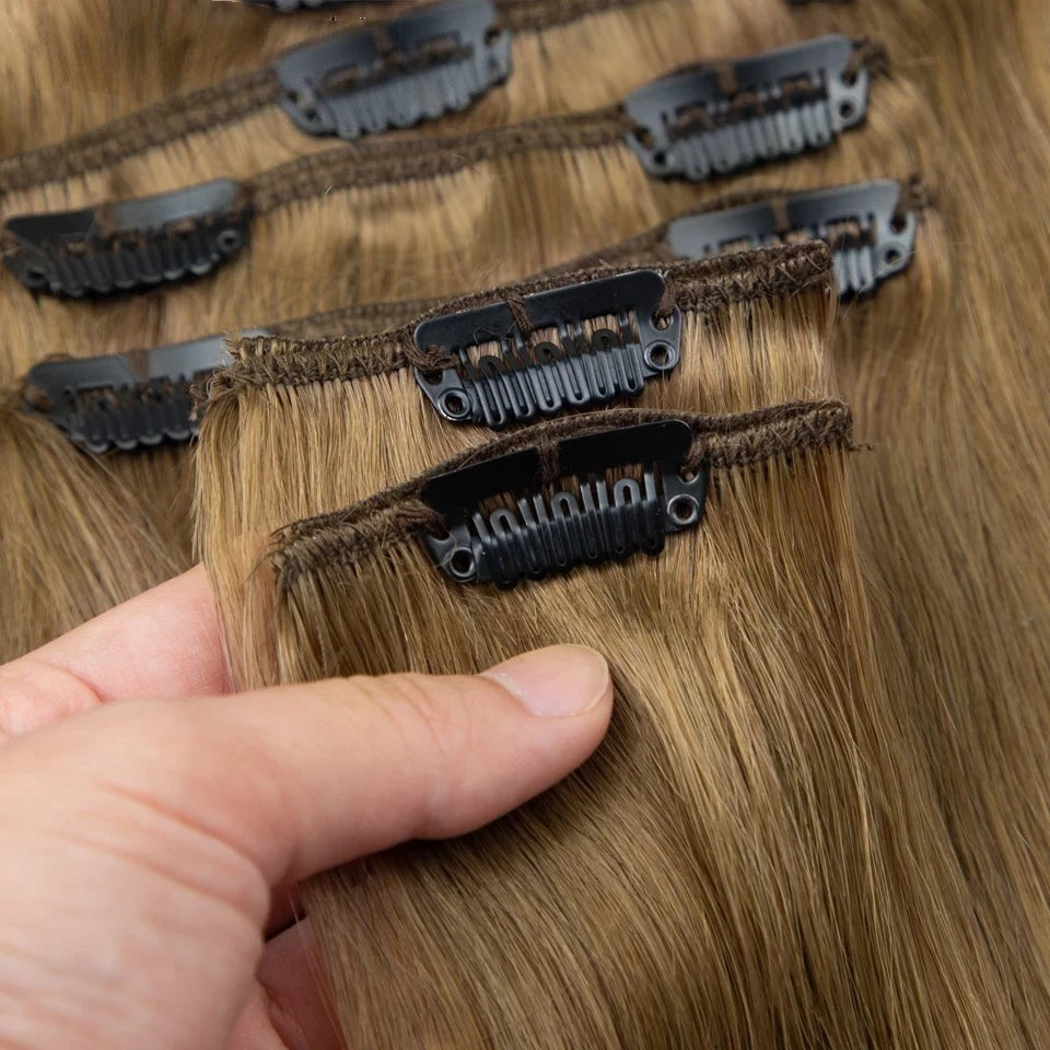 RitzWigs straight human hair extensions in light brown with secure black clips for easy application.